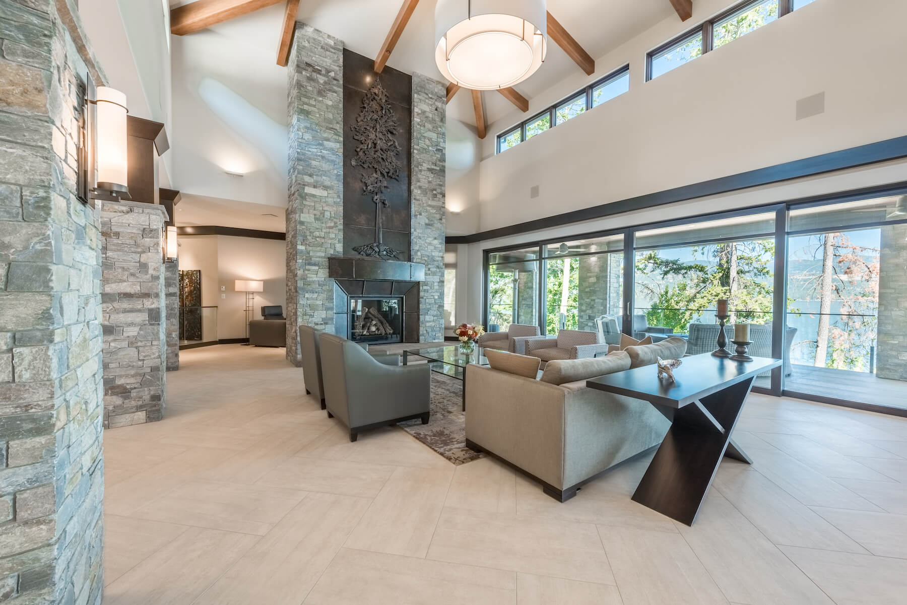 Lakefront custom estate home in Vernon with retractable screens and stone fireplace, built by Vernon custom home builder Bercum Builders